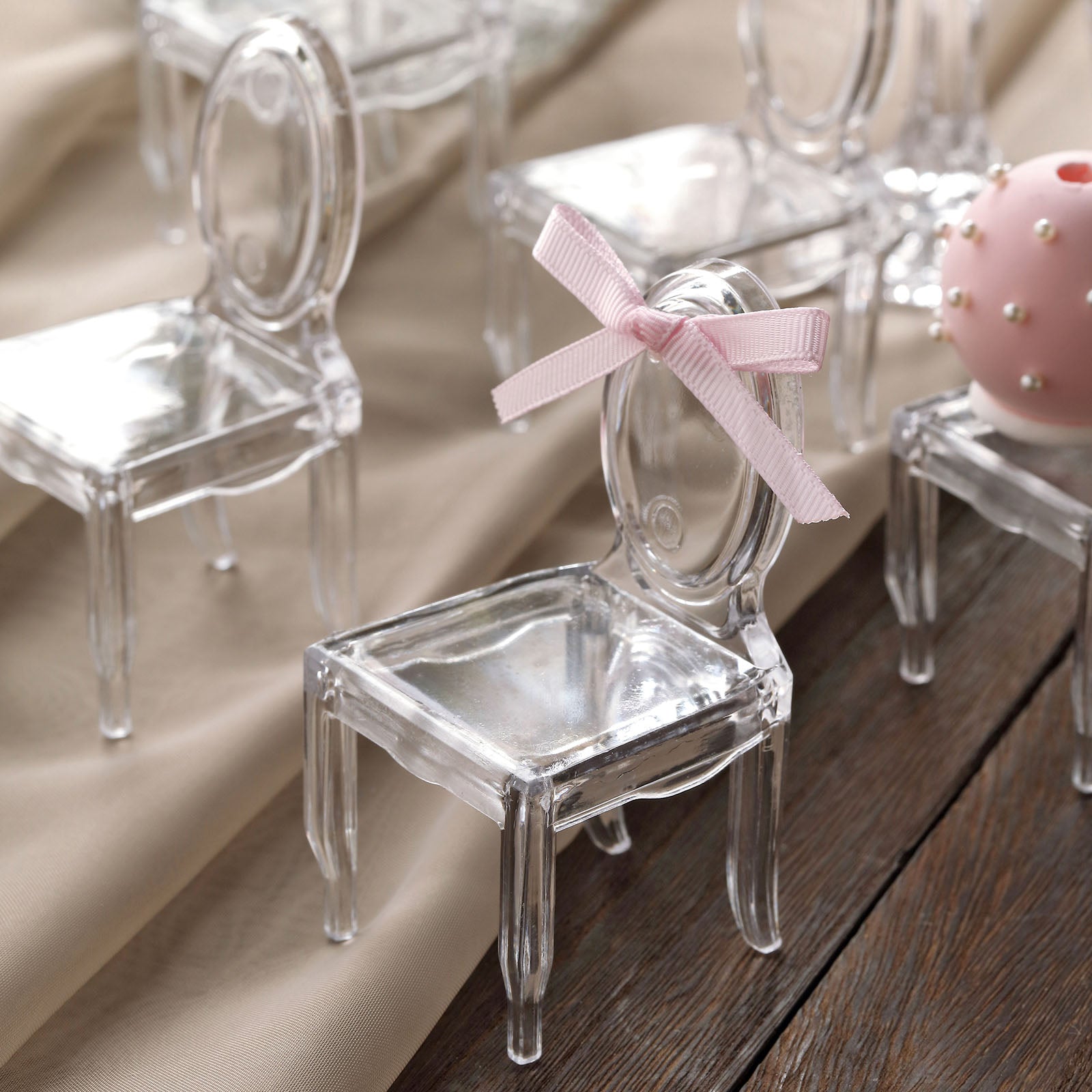 Clear chair-shaped party favor holders for candy treats.