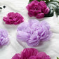 Lavender and lilac giant paper flowers in assorted sizes.