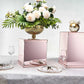 Rose gold mirrored acrylic pedestal risers with interchangeable lid and base.