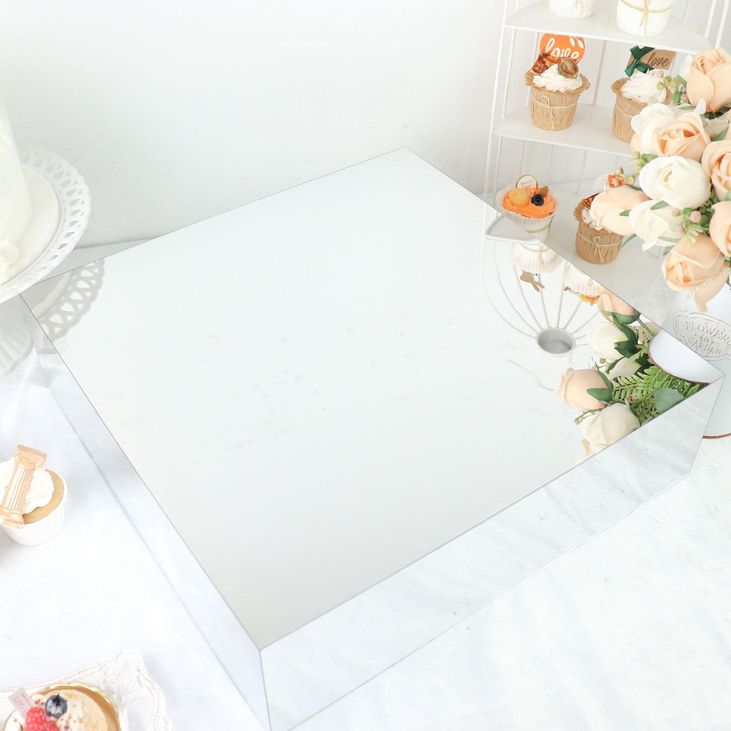 Silver acrylic cake box stand with a mirror finish, perfect for display.