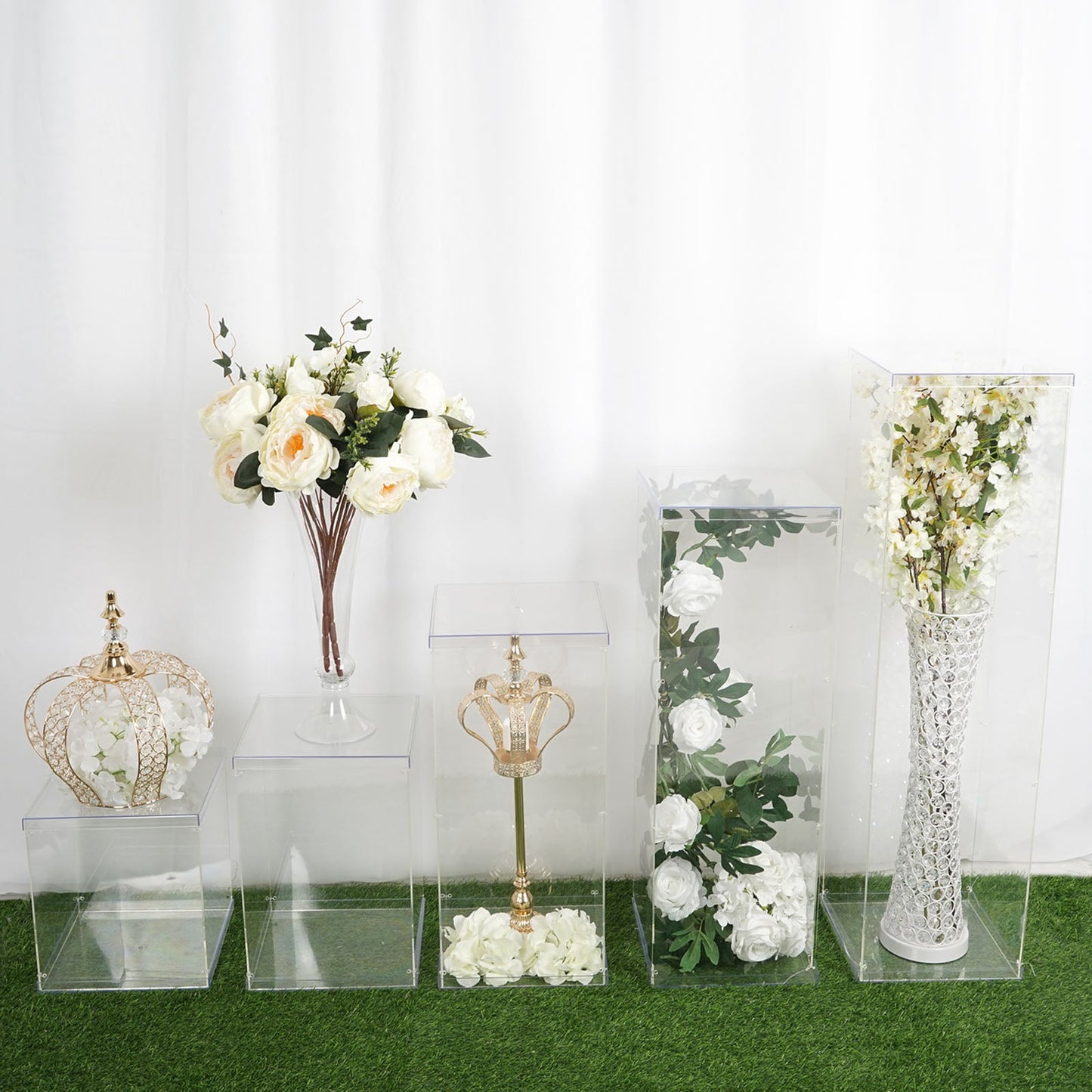 Clear acrylic pedestal risers and display boxes with interchangeable lids.
