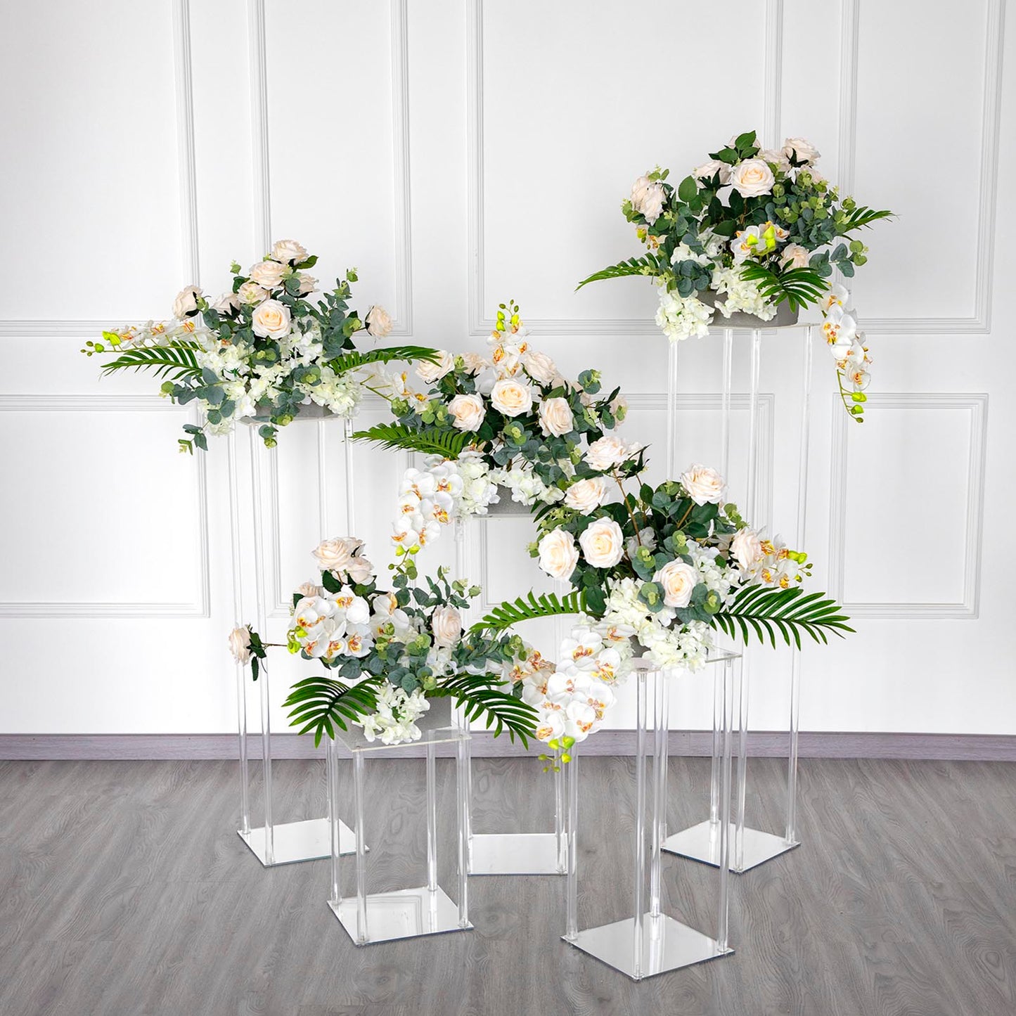 Clear acrylic wedding centerpiece vase with square mirror base and floral arrangement.