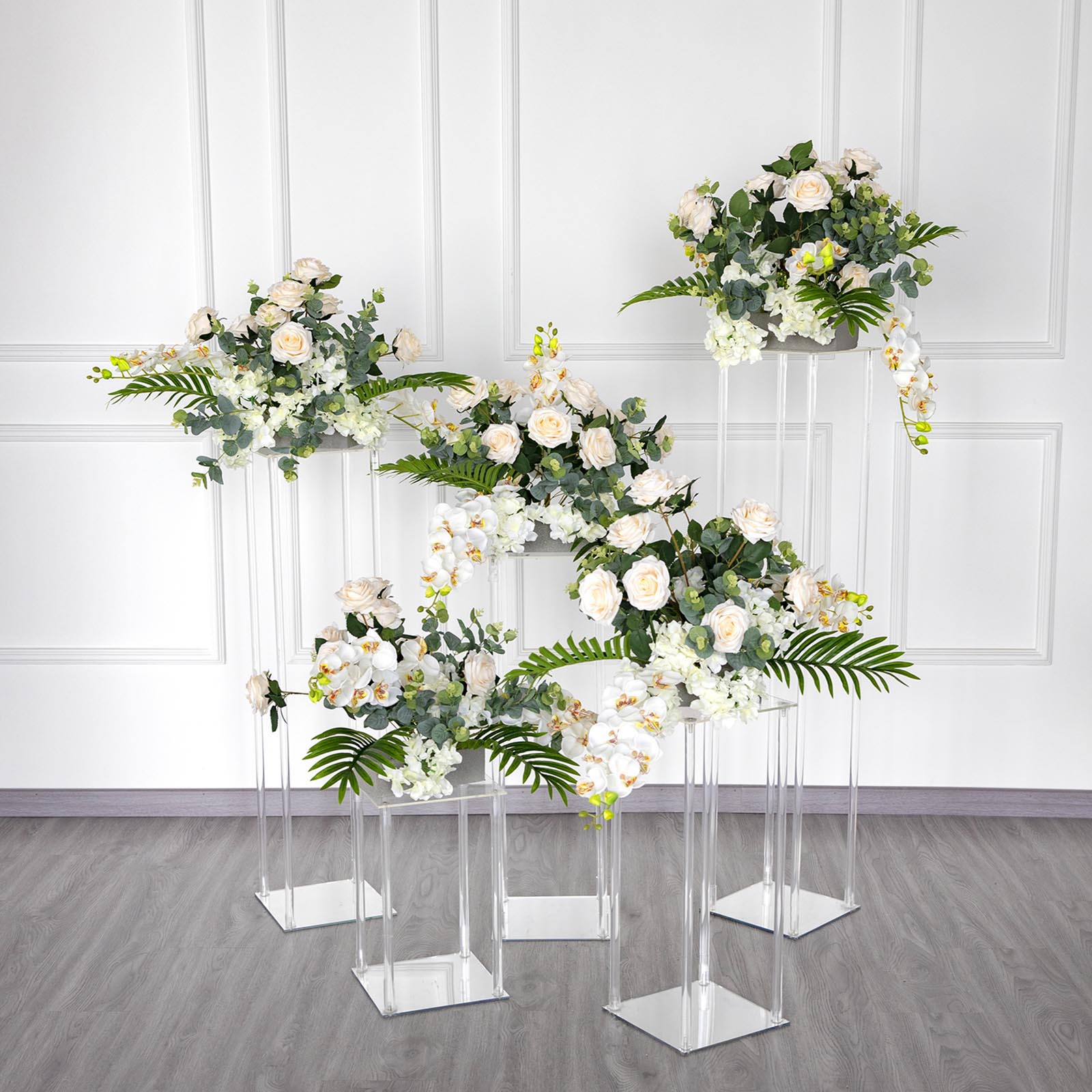 Clear acrylic wedding centerpiece vase with square mirror base and floral arrangement.