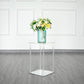 Clear acrylic wedding vase with square mirror base, featuring a flower arrangement.