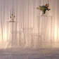 Clear acrylic pedestal stands with hanging hooks for wedding display.