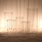 Clear acrylic pedestal stands with hanging hooks for cake display.