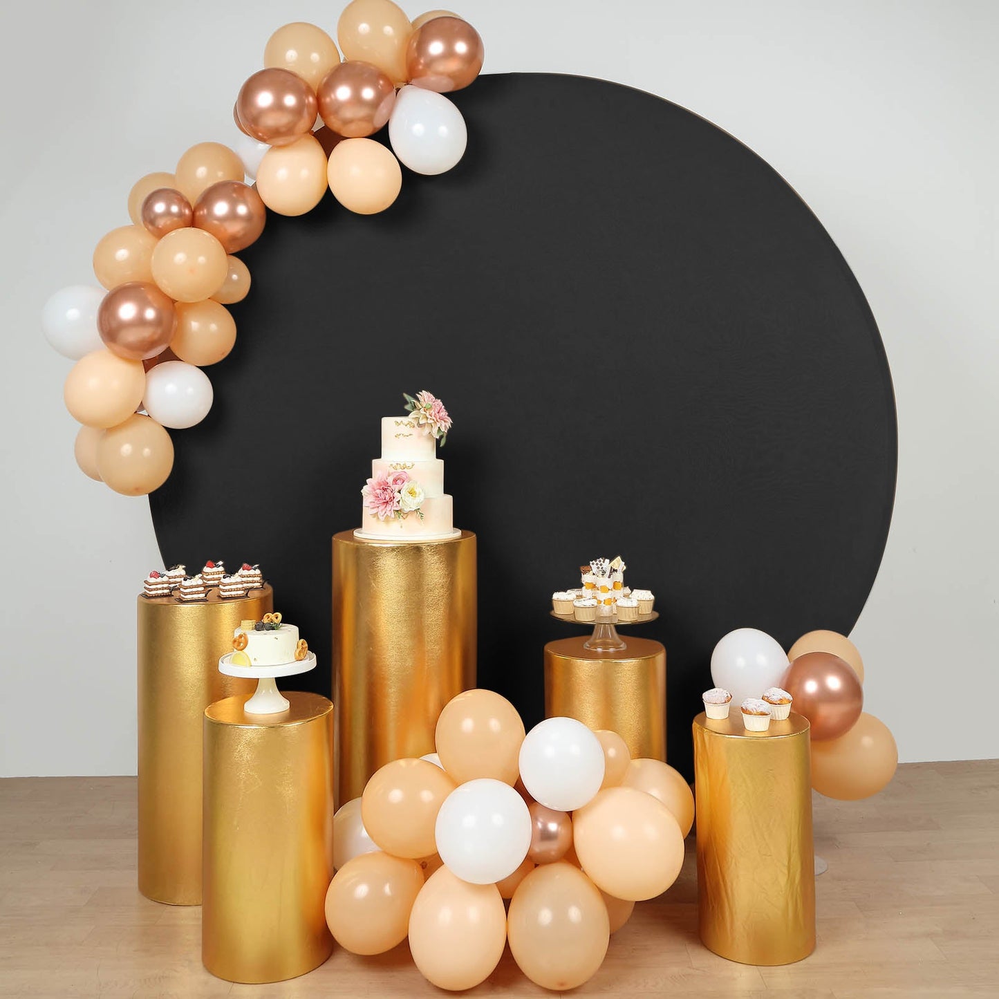 Metallic gold pedestal stand covers on shiny gold displays with balloons.