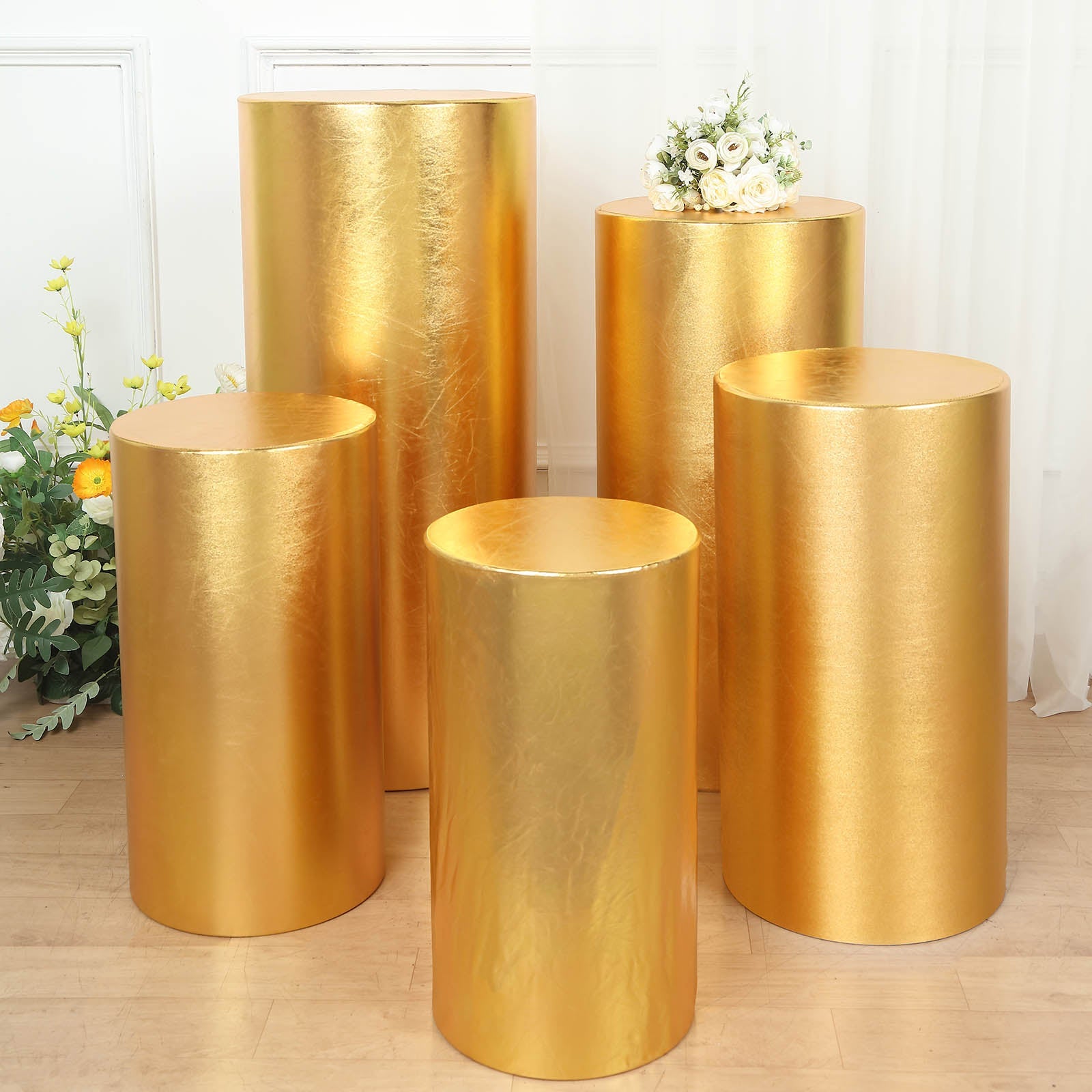 Set of 5 shiny metallic gold pedestal stand covers.