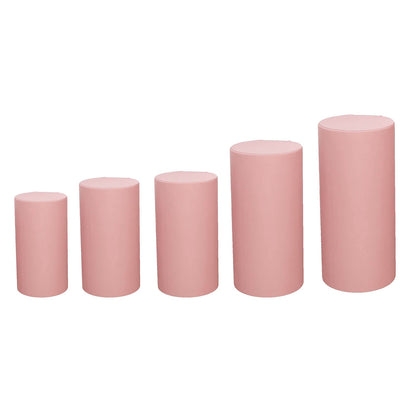 Dusty rose spandex pedestal stand covers in a set of five.