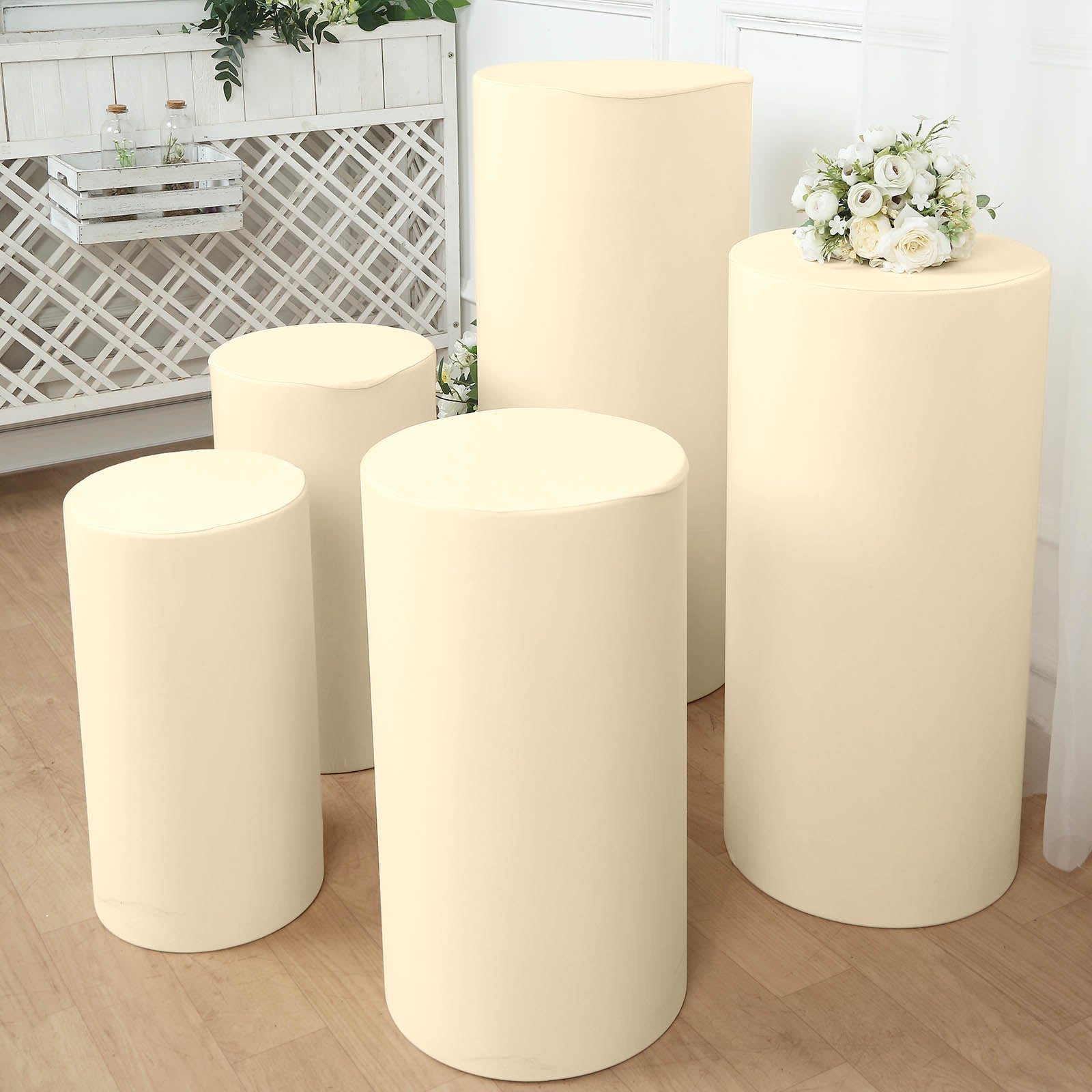 Beige spandex pedestal stand covers set of 5 for events and displays.
