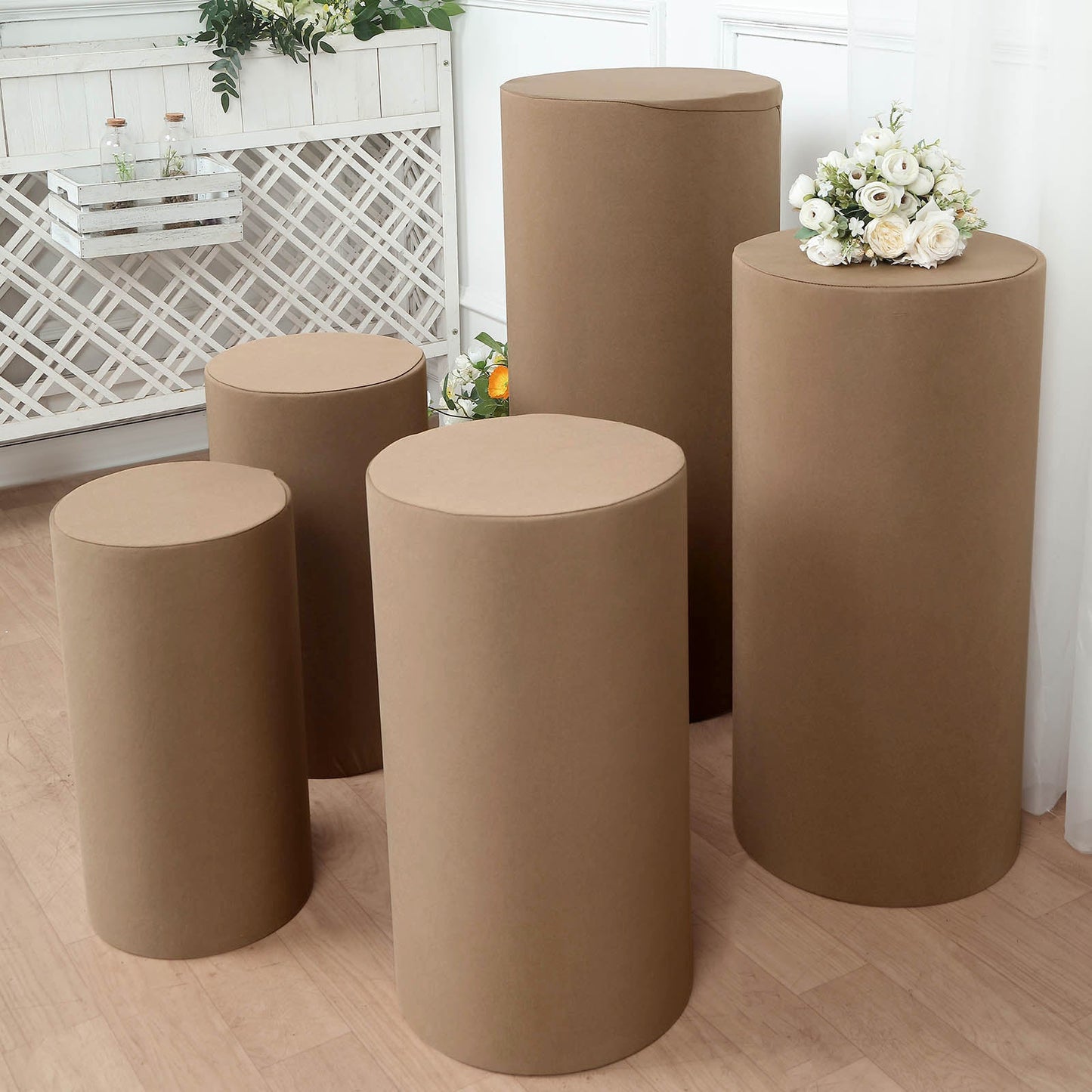 Taupe spandex pedestal stand covers for stylish event decor.