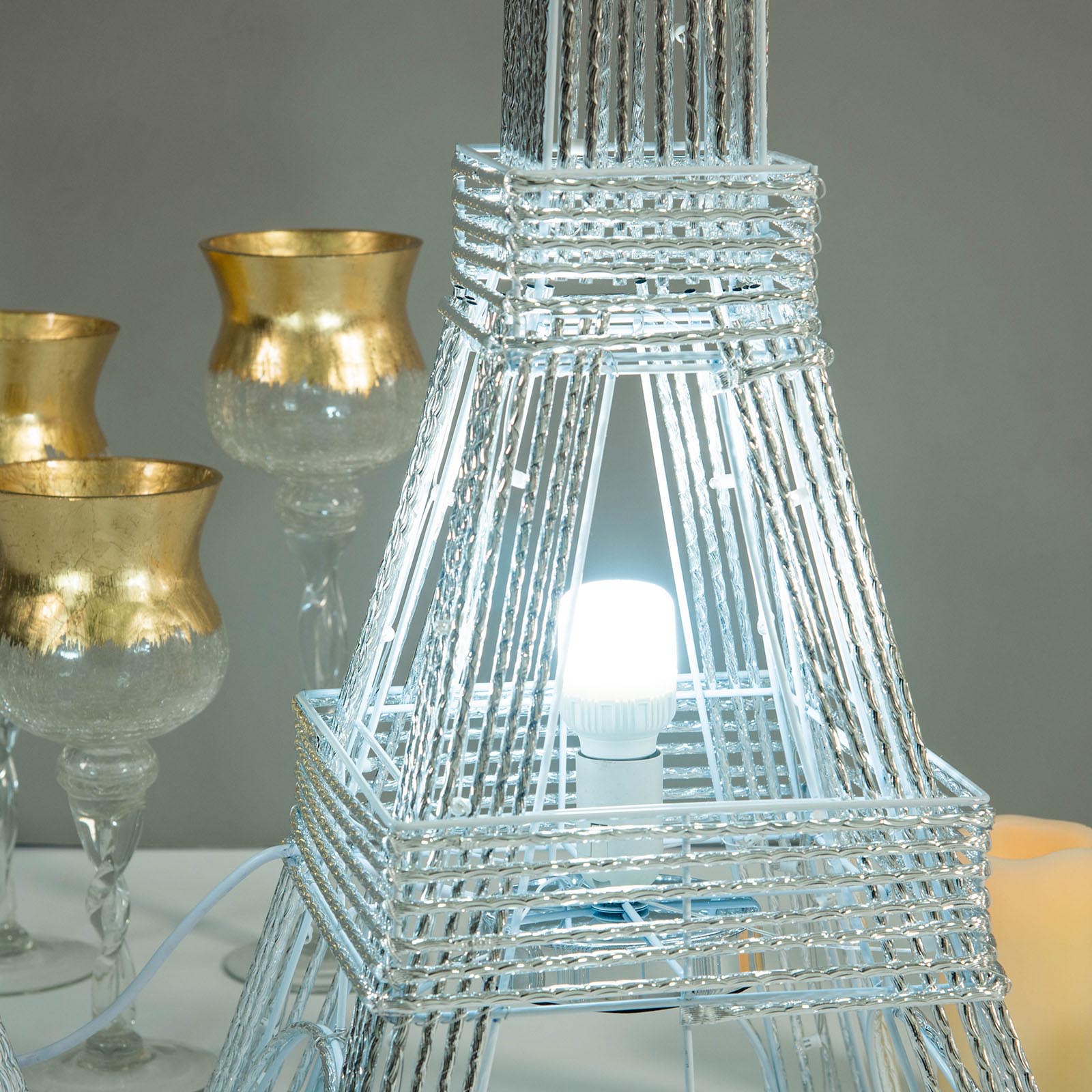 Color changing LED metal Eiffel Tower in silver with warm light.
