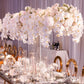 Clear acrylic rectangular flower stand with white floral arrangement.