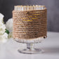 Natural jute rope twine wrapped around a glass candle holder.