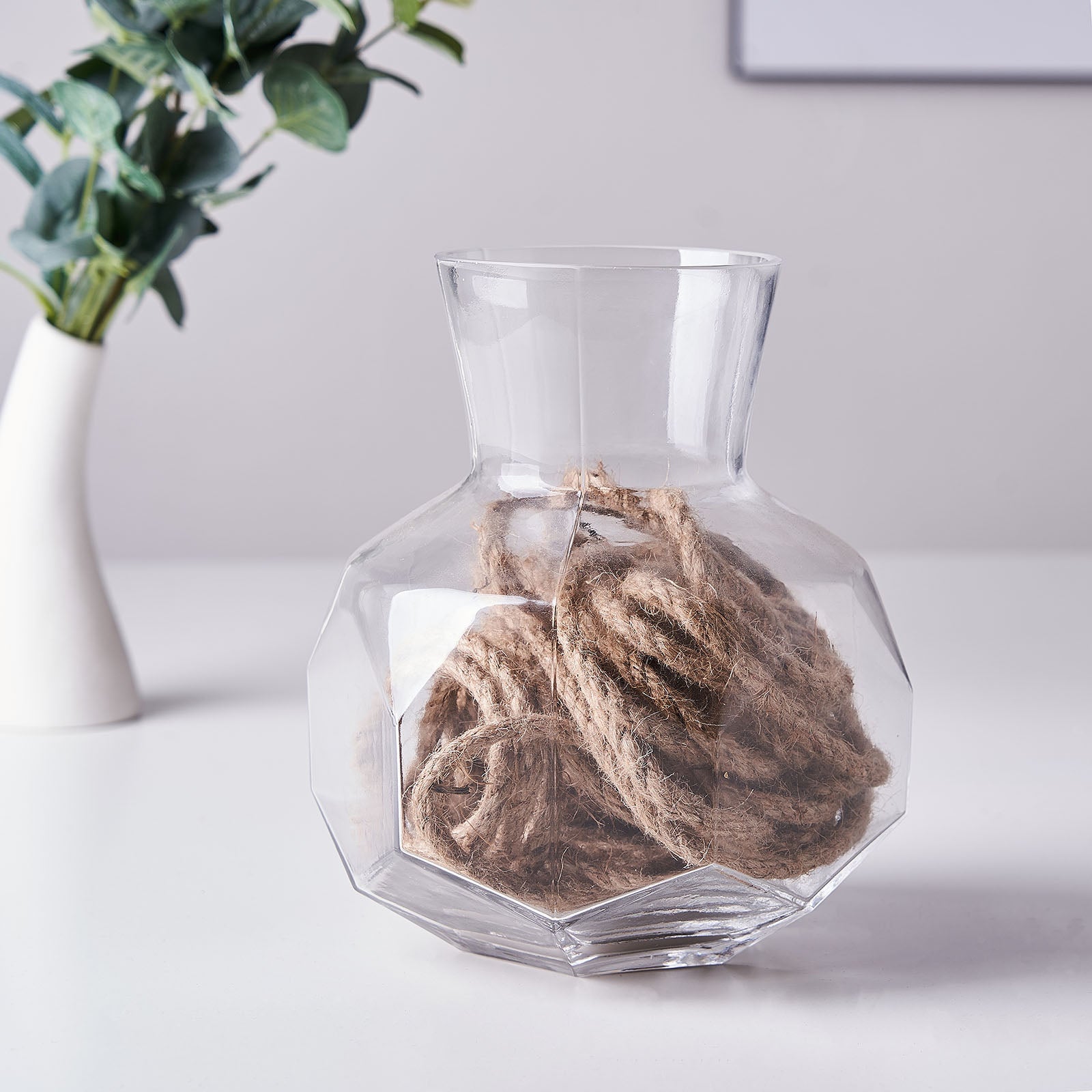 Natural jute rope twine in a clear vase for DIY crafts.