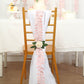 Dusty rose leaf petal taffeta ribbon sash on a chair.