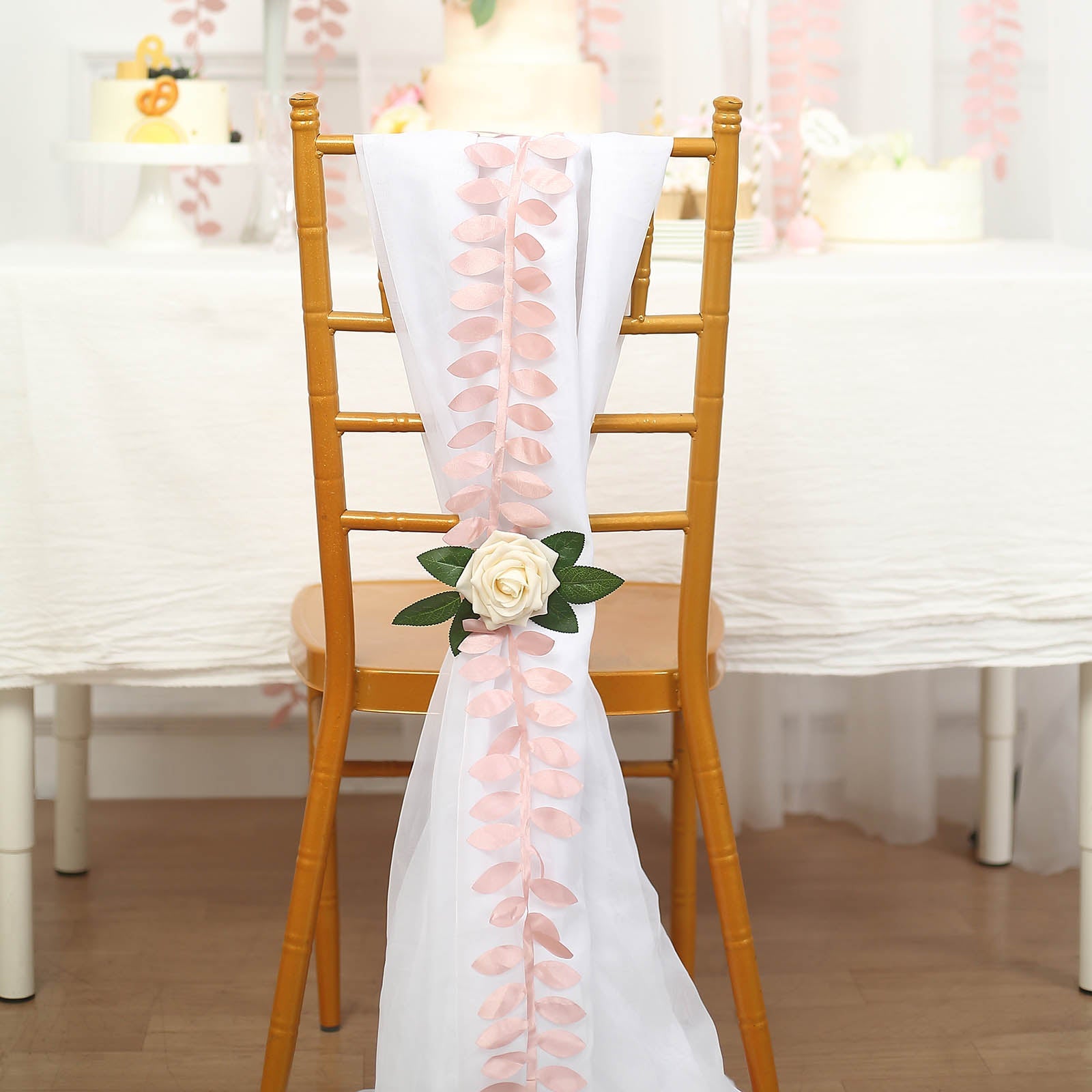 Dusty rose leaf petal taffeta ribbon sash on a chair.