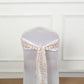 Beige leaf petal taffeta ribbon sash on a white chair.