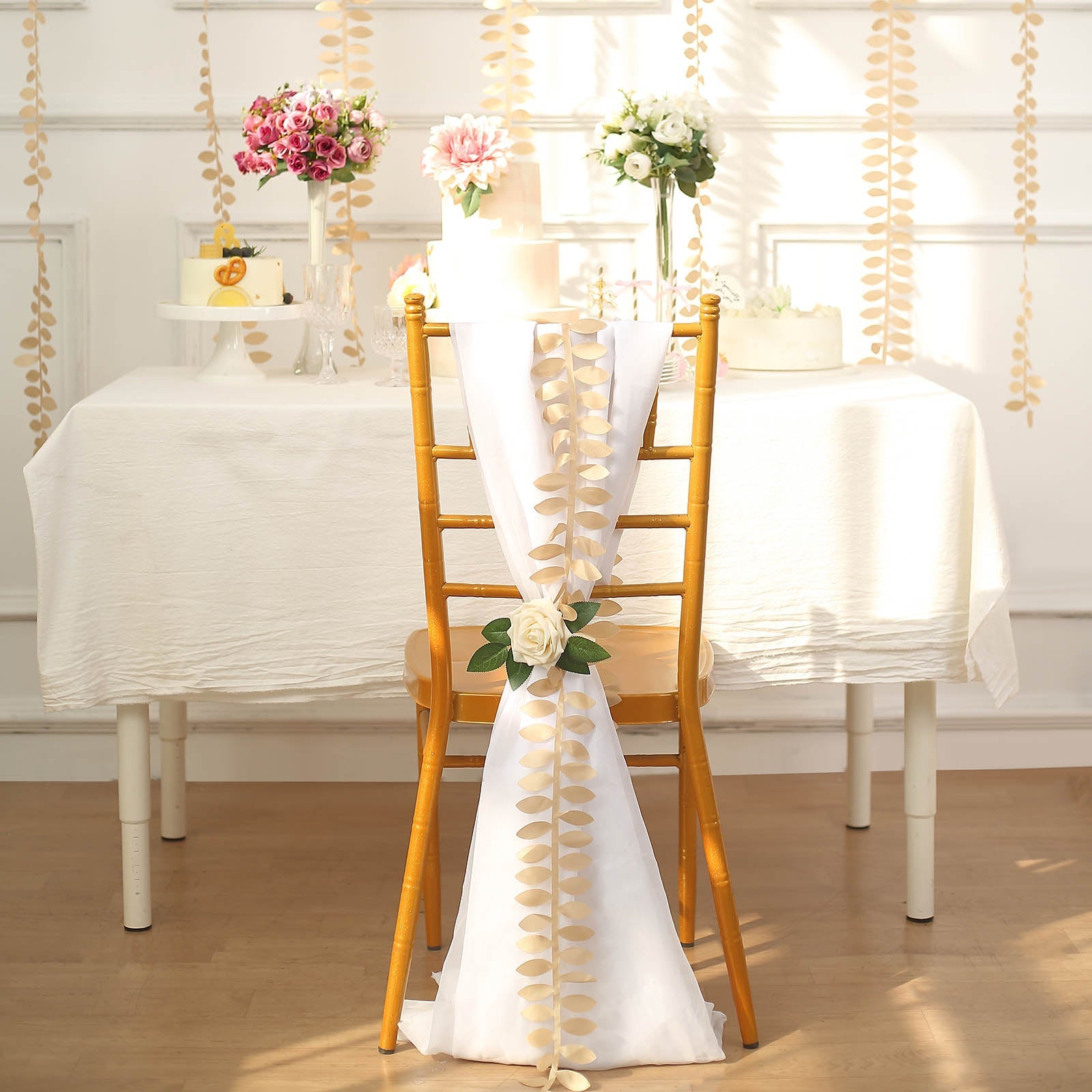 Champagne leaf petal taffeta ribbon sash on a decorated chair.