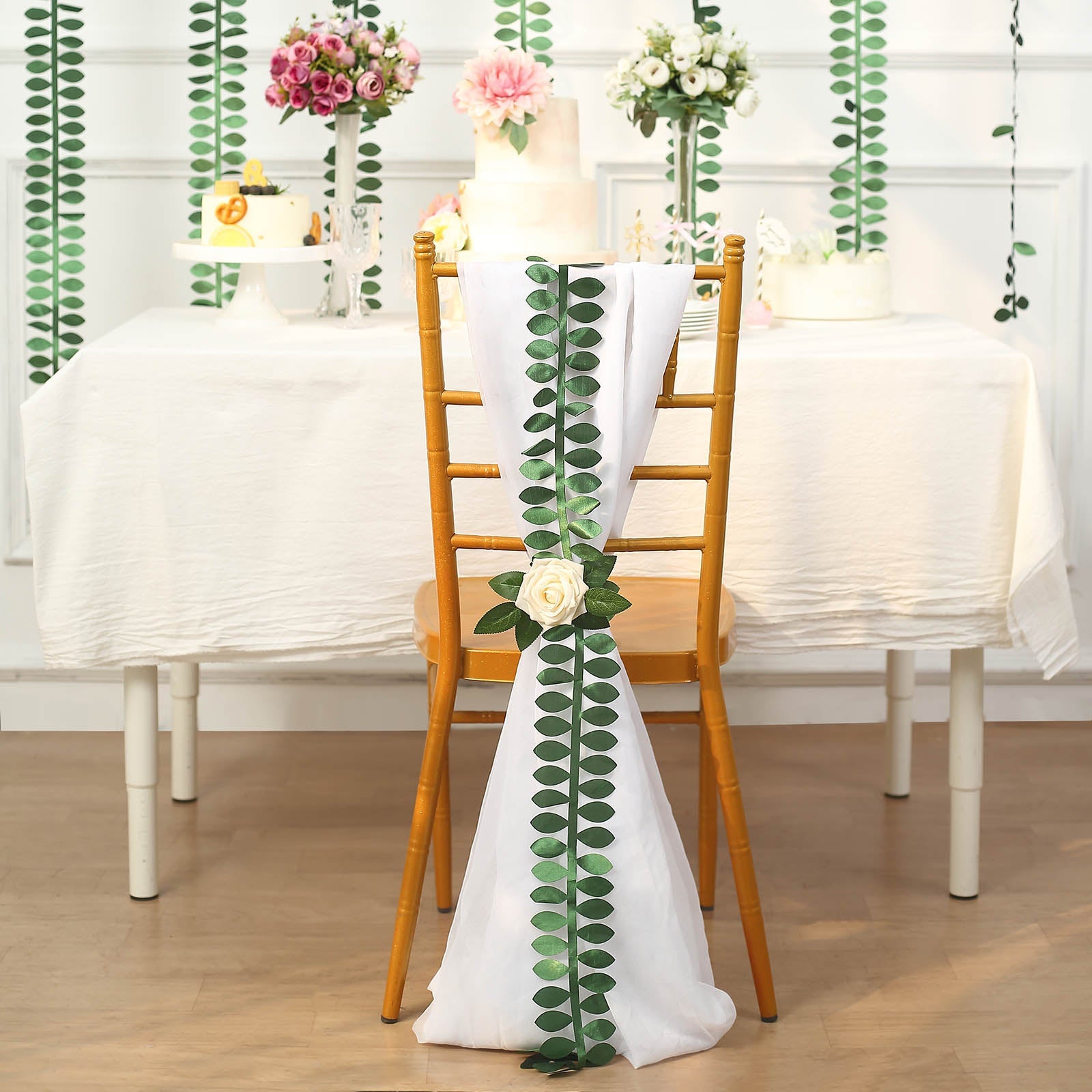 Green leaf petal taffeta ribbon sash on a decorated chair.