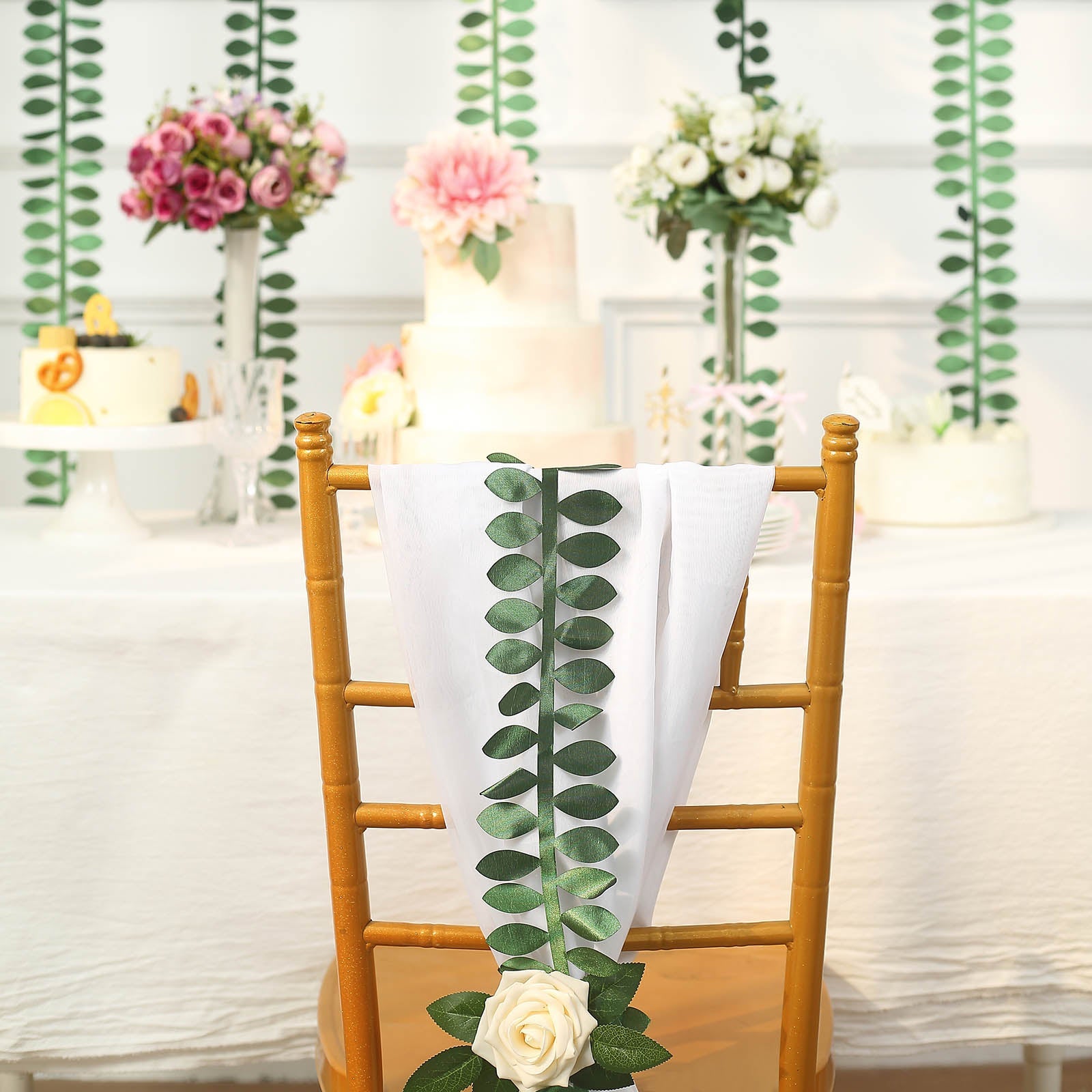 Green leaf petal taffeta ribbon sash on a decorated chair for DIY garlands.