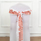 Terracotta leaf petal taffeta ribbon sash on a white chair.