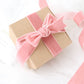 Dusty rose velvet ribbon spool for DIY crafts.