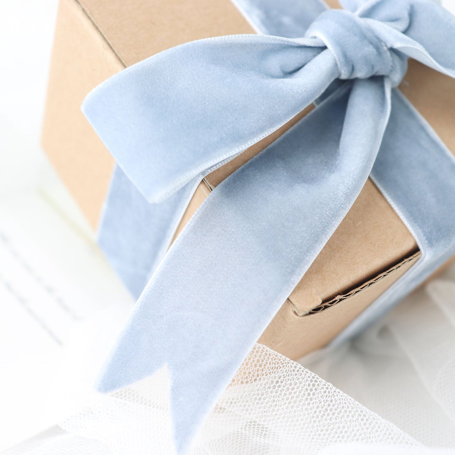 Dusty blue velvet ribbon on a gift box, perfect for DIY crafts.