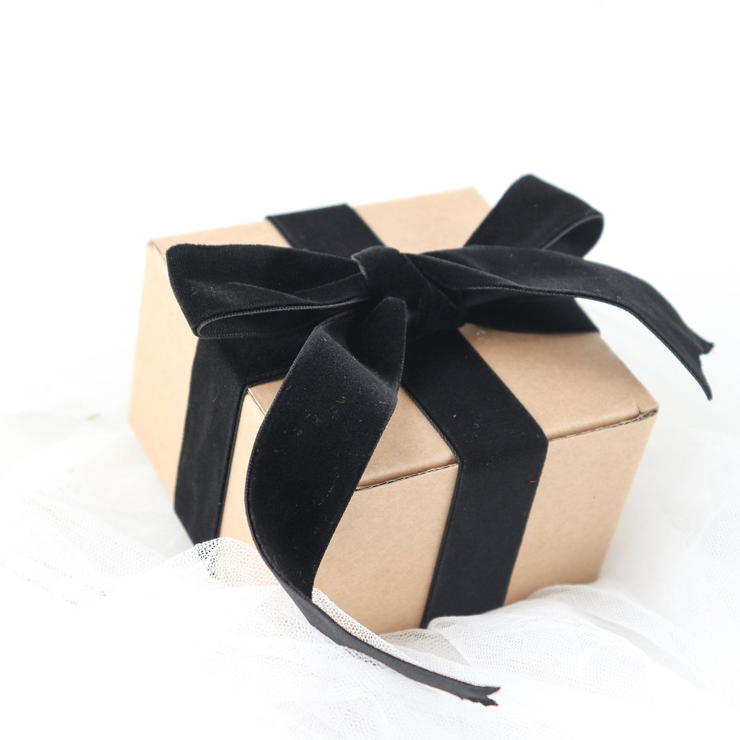 Black velvet ribbon on a gift box, perfect for DIY crafts and decorations.