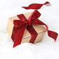 Burgundy velvet ribbon on a gift box with a bow.