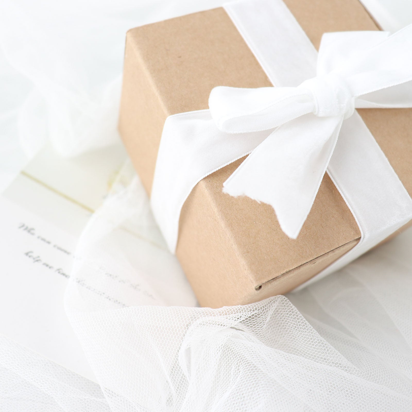 White velvet ribbon on a gift box, perfect for DIY crafts.