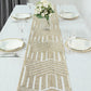 Champagne sequin table runner on a dining table with floral centerpiece.