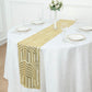 Gold sequin table runner on a white tablecloth with elegant table setting.