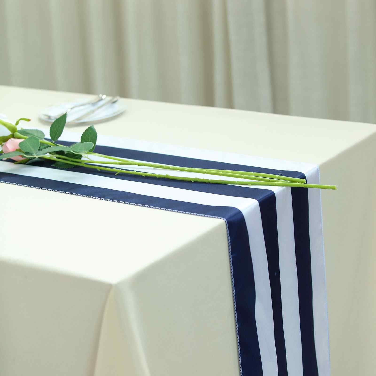 Navy and white stripe satin table runner on a light tablecloth.