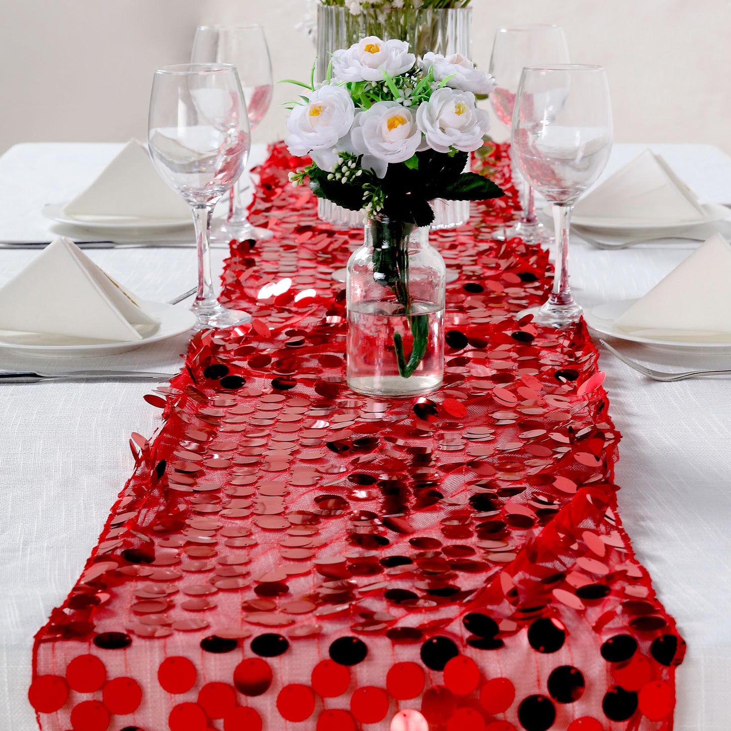 Red sequin table runner for elegant table settings.