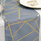 Dusty blue table runner with gold foil geometric pattern.