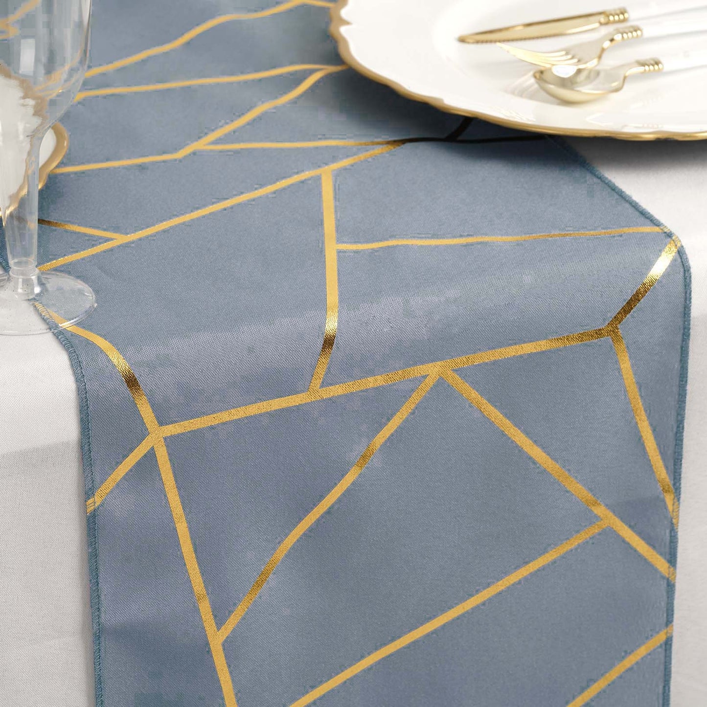 Dusty blue table runner with gold foil geometric pattern.