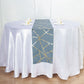 Dusty blue and gold foil geometric pattern table runner on a white table.