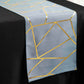 Dusty blue geometric table runner with gold foil accents.