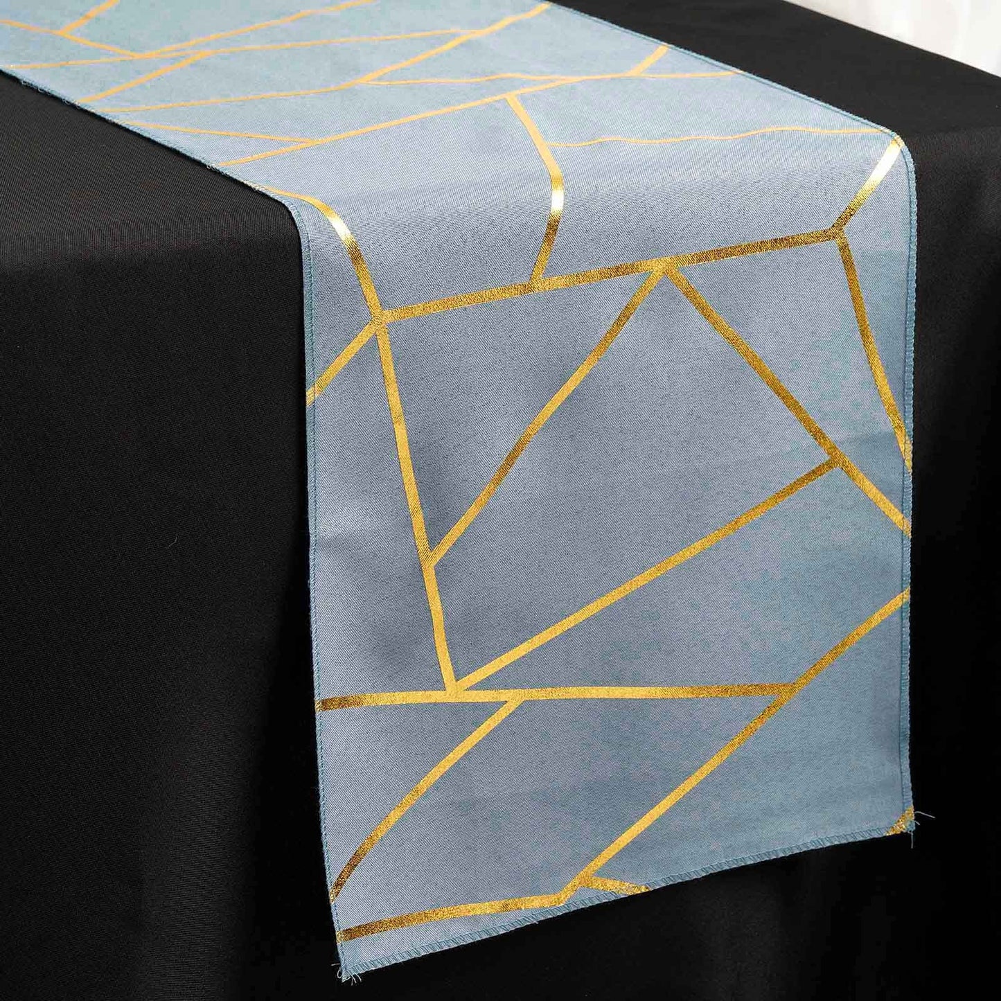 Dusty blue geometric table runner with gold foil accents.