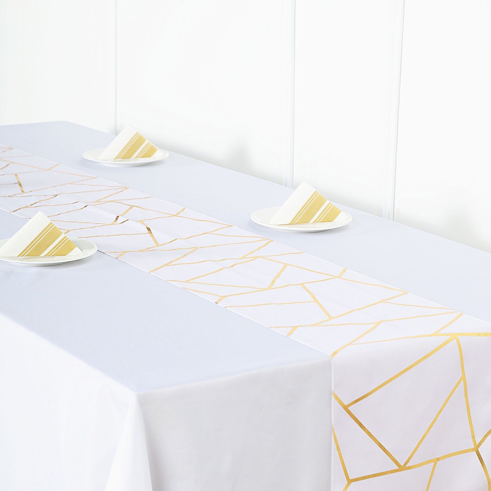 9ft white and gold geometric pattern table runner on a dining table.
