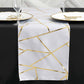 9ft white and gold foil geometric pattern table runner on a black table.