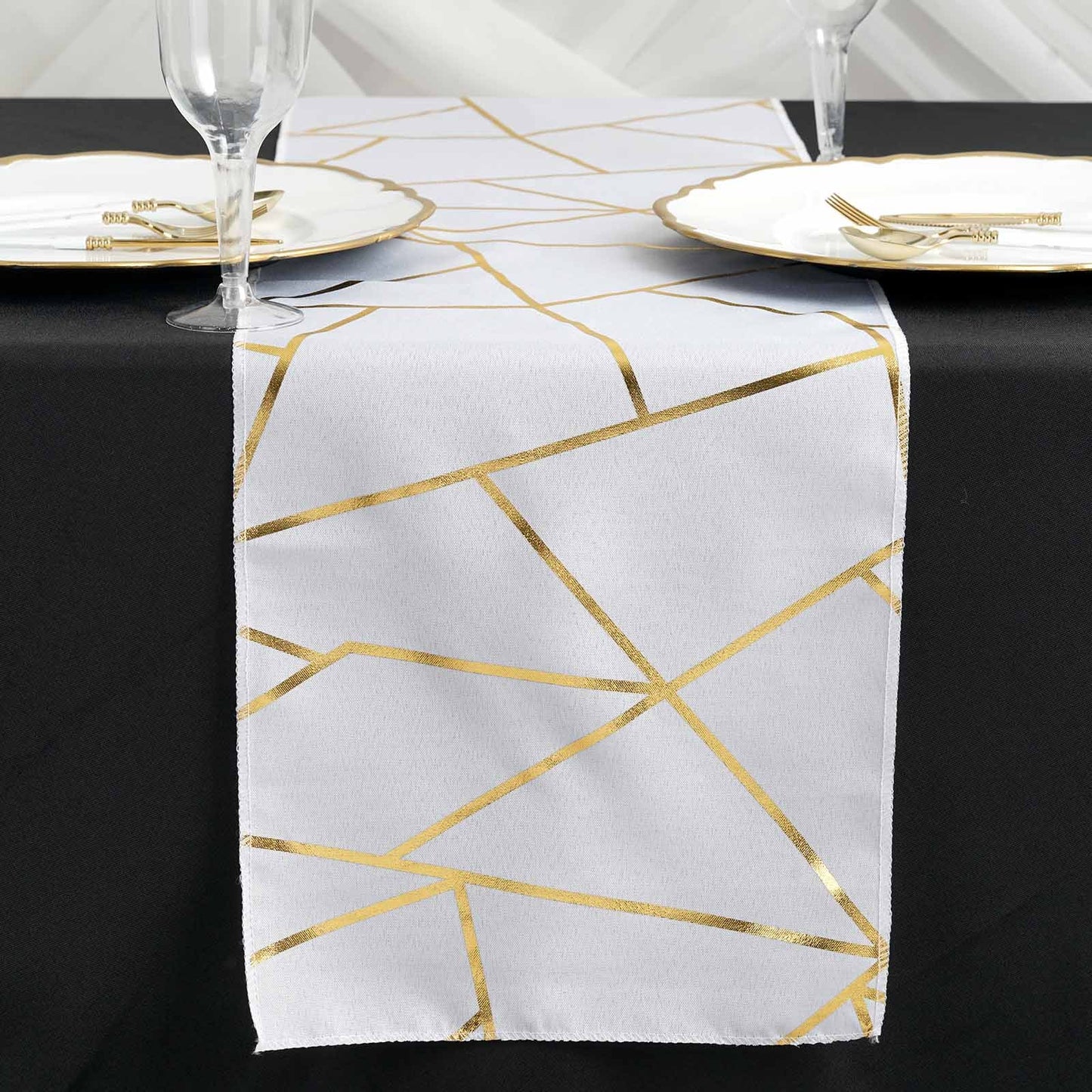 9ft white and gold foil geometric pattern table runner on a black table.