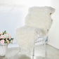 White fluffy faux sheepskin rug runner on a chair.
