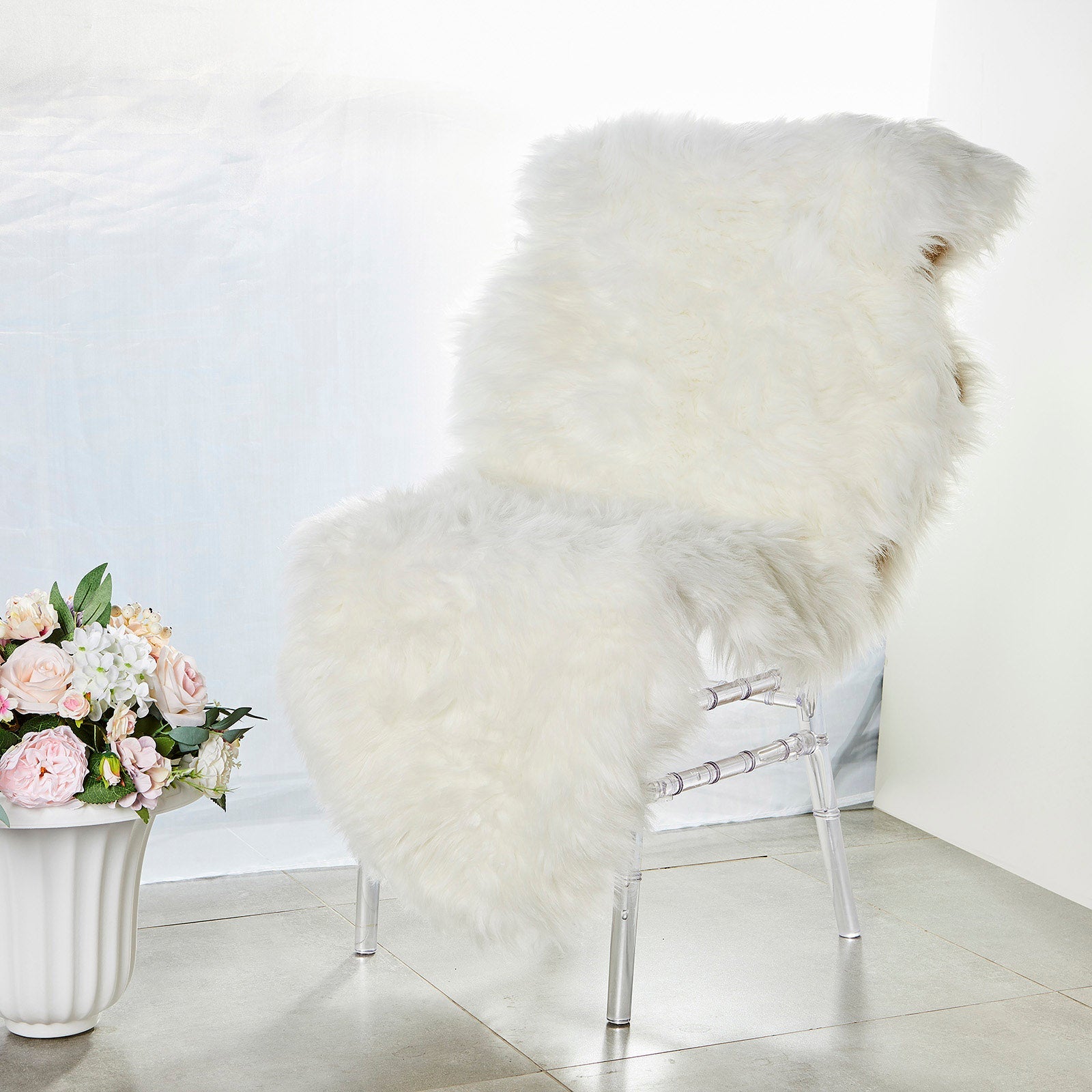 White fluffy faux sheepskin rug runner on a chair.