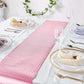 Rose gold sequin print table runner on a dining table setting.