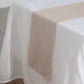 Taupe linen table runner on a white tablecloth.