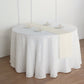 Ivory linen table runner on a round table with decorative plates.