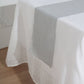 Silver linen table runner on a white table.