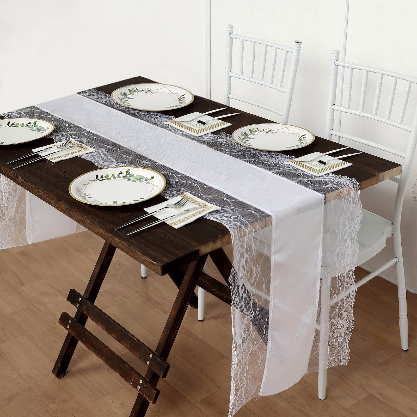 White faux burlap jute table runner with lace edging on a rustic table setting.